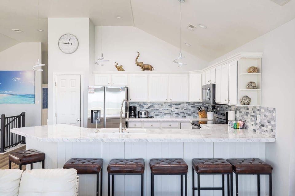 Top Level: Bright, Fully Stocked Kitchen with Breakfast Bar Seating
