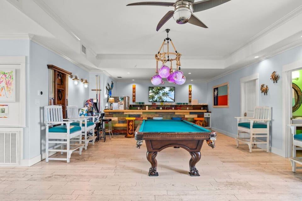 Ground floor game room with pool table and seating