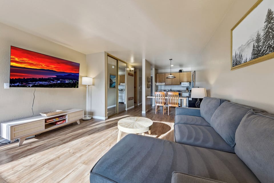Sink into the plush sofa and enjoy your favorite shows on the large flat-screen TV in this bright, open living space.