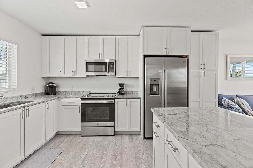 Start your morning with coffee from the Keurig coffee maker in this inviting vacation rental kitchen at Ocean Isles #123 in Marathon FL.