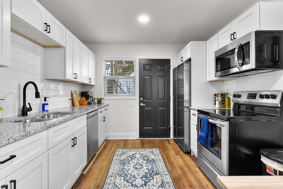Your bright, modern kitchen awaits with granite counters and stainless steel appliances for culinary adventures.