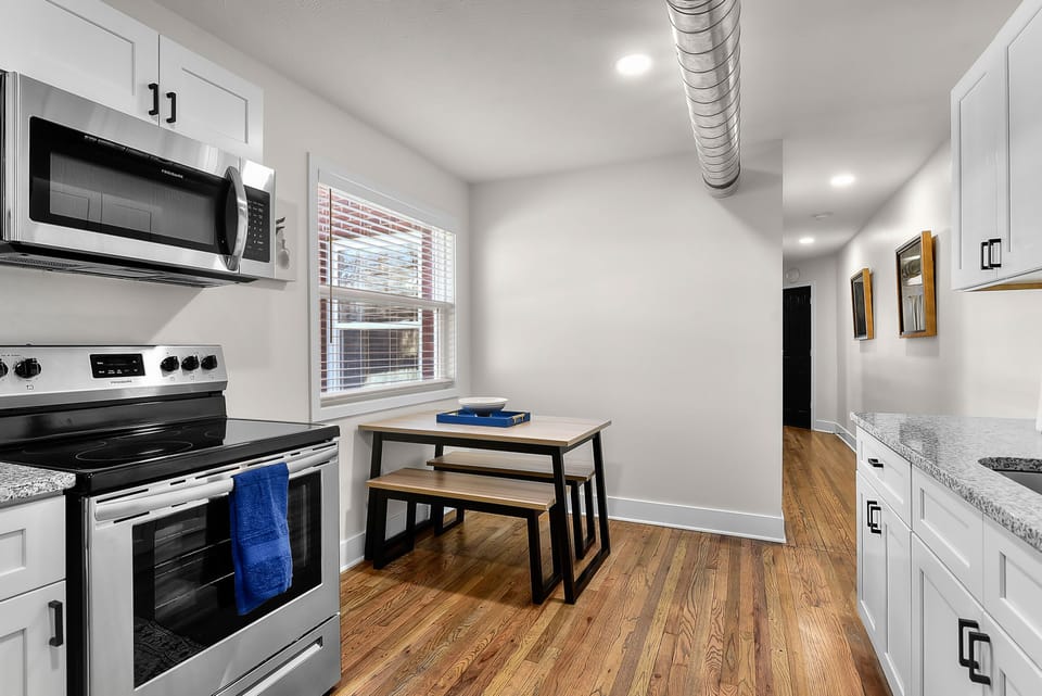 Your sleek galley kitchen features modern appliances and a cozy dining nook, perfect for morning coffee or casual meals.