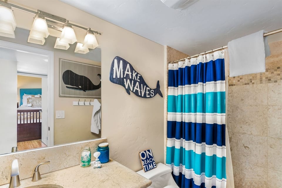 Full size bathroom with a shower across the hallway from Bedroom 2 and Bedroom 3.