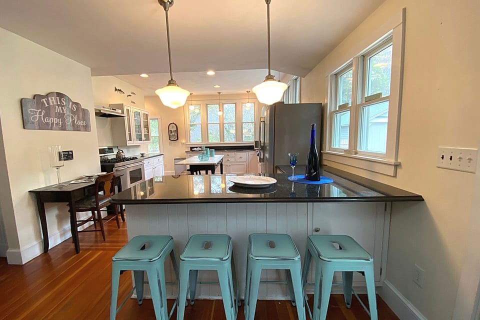 Additional seating for 4 is available at the kitchen counter, providing a cozy spot for casual meals, snacks, or morning coffee.