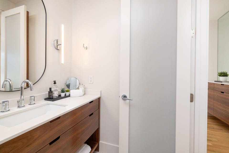 Primary Bathroom with shower/tub combo and large sink.
