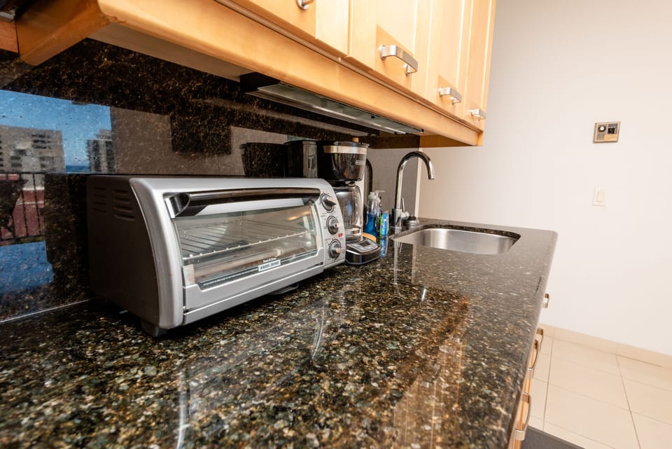 Kitchenette feature toaster oven, built in microwave, and 2 burner cooktop