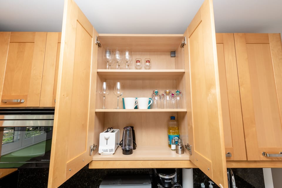 Cabinets stocked with cooking and dining essentials
