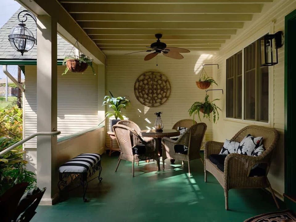 This lanai is perfect for relaxing—cozy wicker seating, tropical plants, and breezy island vibes.