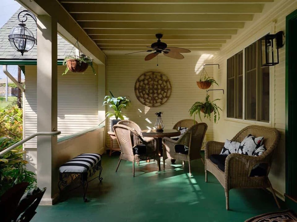 This lanai is perfect for relaxing—cozy wicker seating, tropical plants, and breezy island vibes.