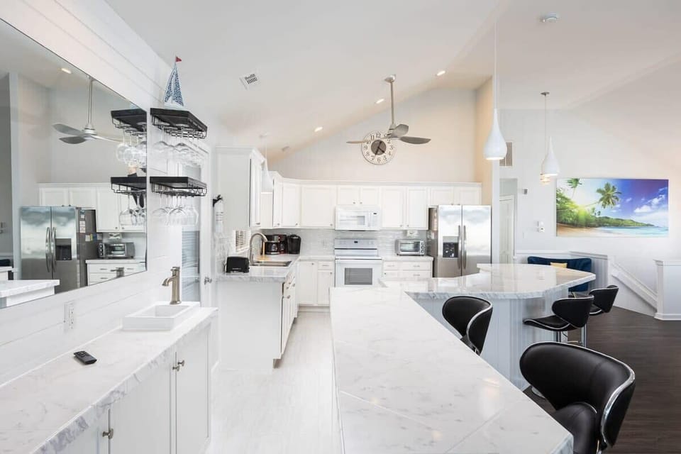 Top Level: Well-stocked kitchen with island bar seating for five (5).