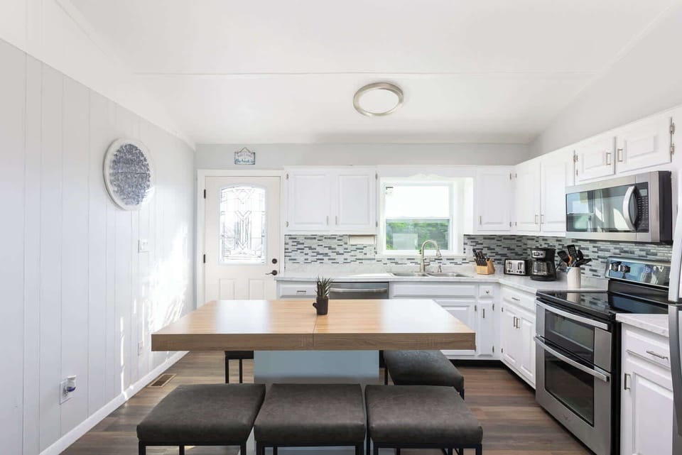 Top Level: Spacious fully equipped kitchen with modern appliances, perfect for cooking and gathering.