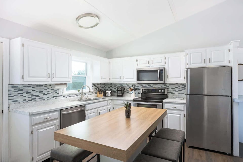 Top Level: Spacious fully equipped kitchen with modern appliances, perfect for cooking and gathering.