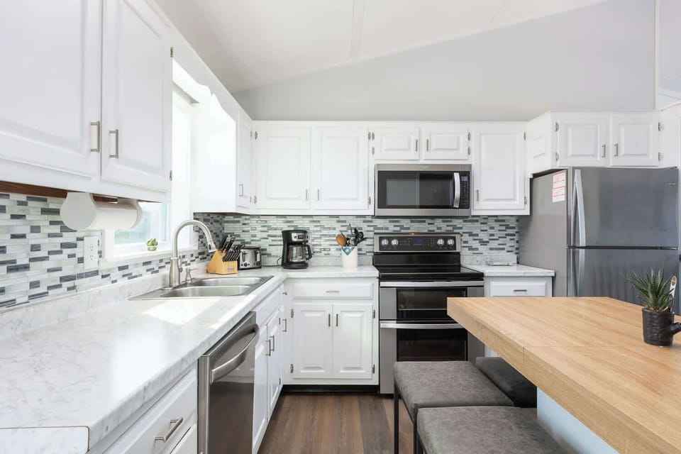 Top Level: Spacious fully equipped kitchen with modern appliances, perfect for cooking and gathering.
