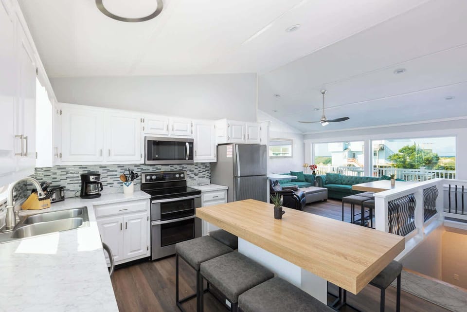 Top Level: Spacious fully equipped kitchen with modern appliances, perfect for cooking and gathering.