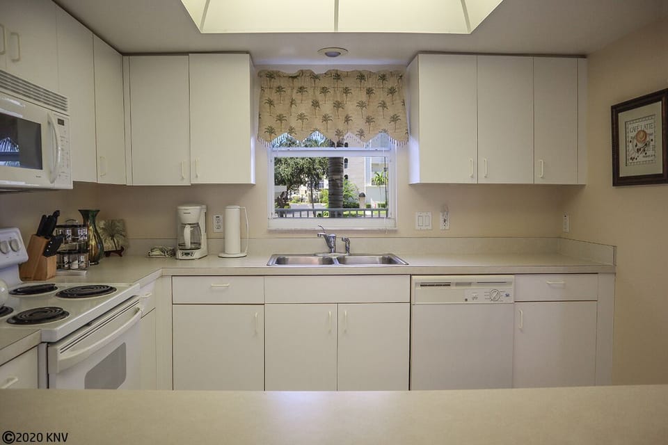 Large clean kitchen is fully equipped.