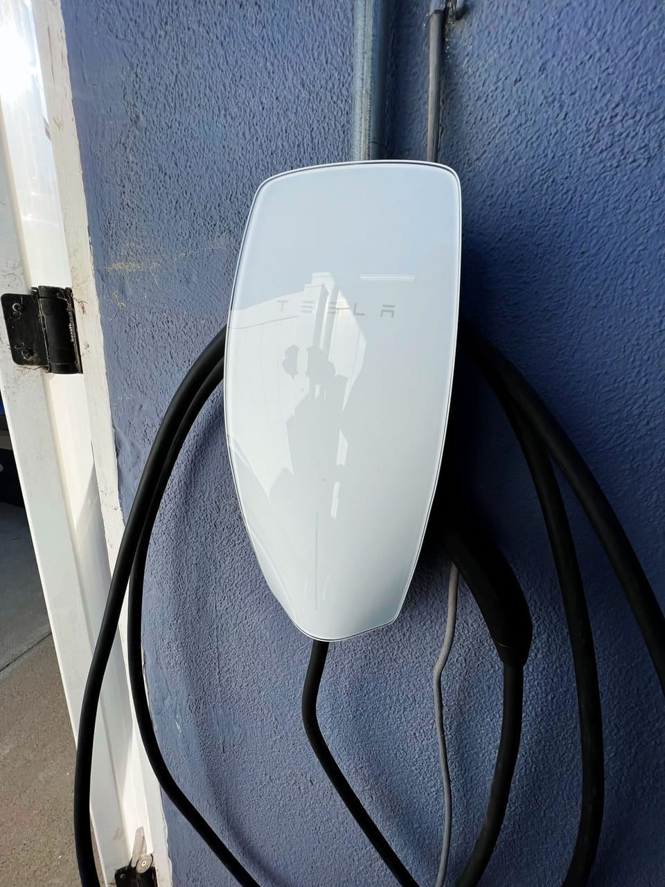 Tesla Type 2 Charger, next to garage.