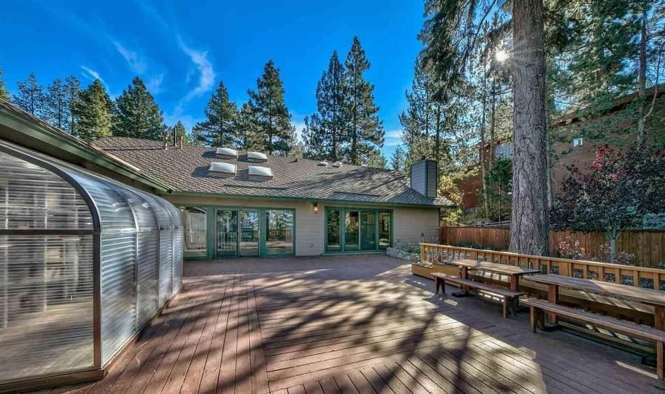 Huge back deck with picnic tables and BBQ