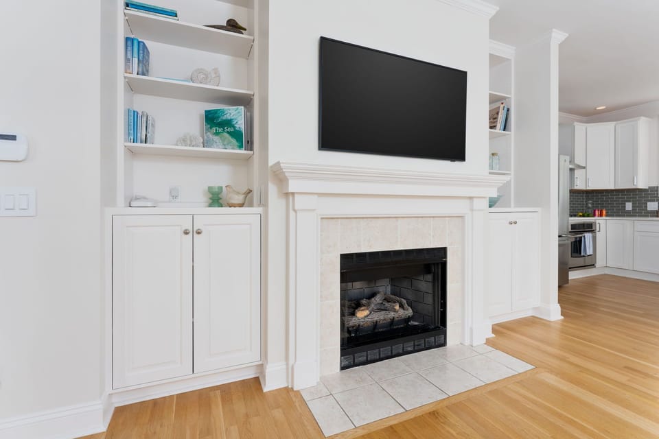 Frame TV, books, and card/board games (inside cabinet).  Fireplace (decorative).