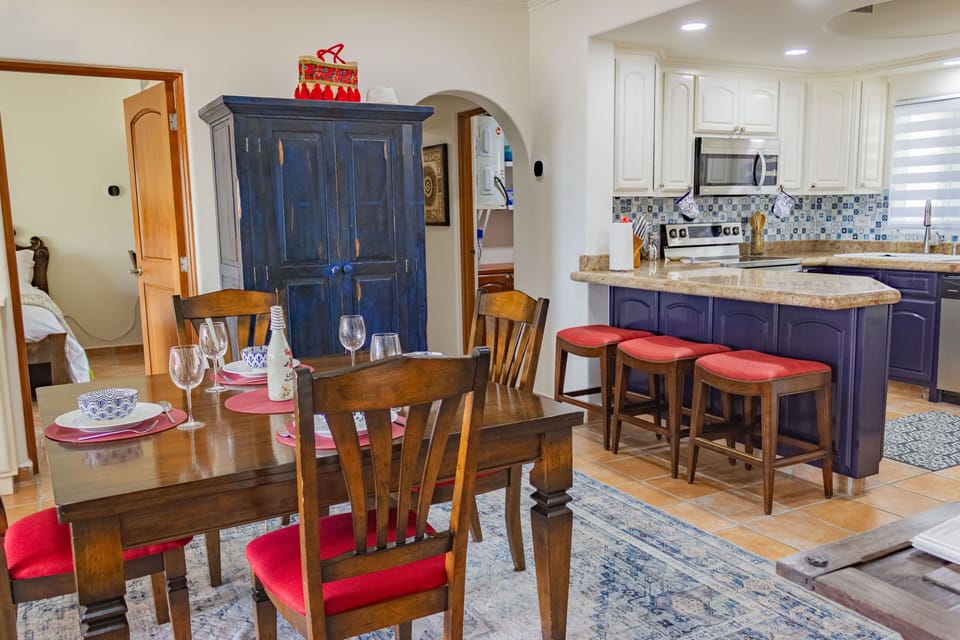 Cook in the bright, fun kitchen while friends watch from the bar.