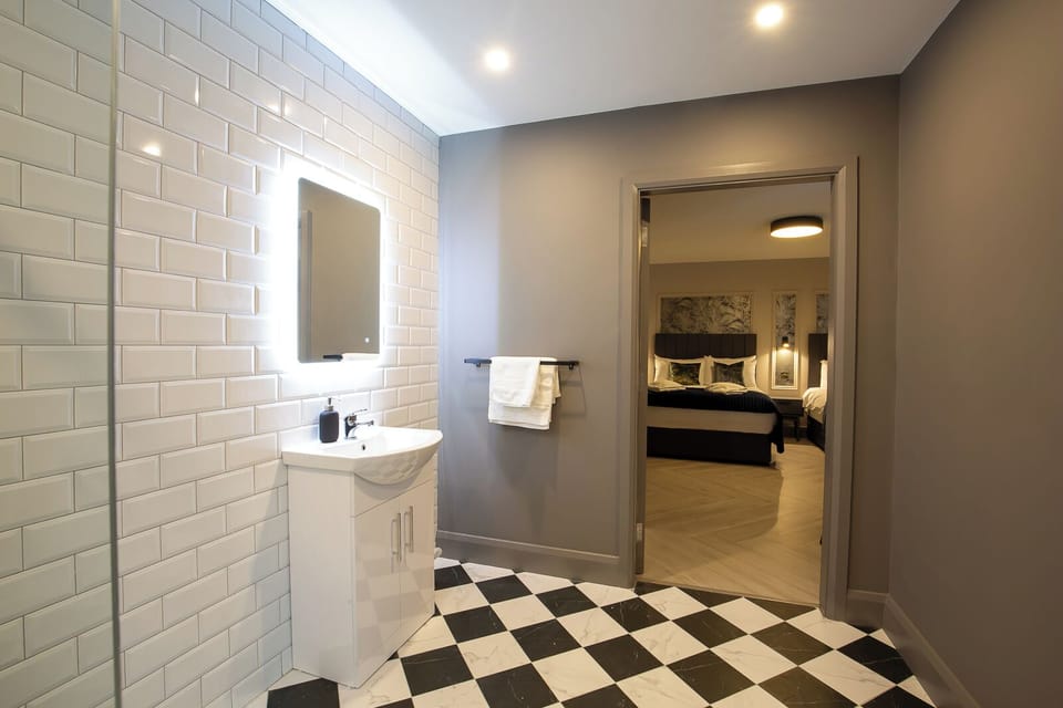 Grand Triple Room | Bathroom | Shower, heated floors, soap, shampoo