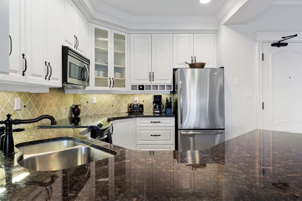 Fully equipped kitchen with stainless steel appliances & granite countertops