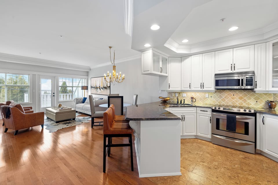Kitchen looking into open concept dining area and living space
