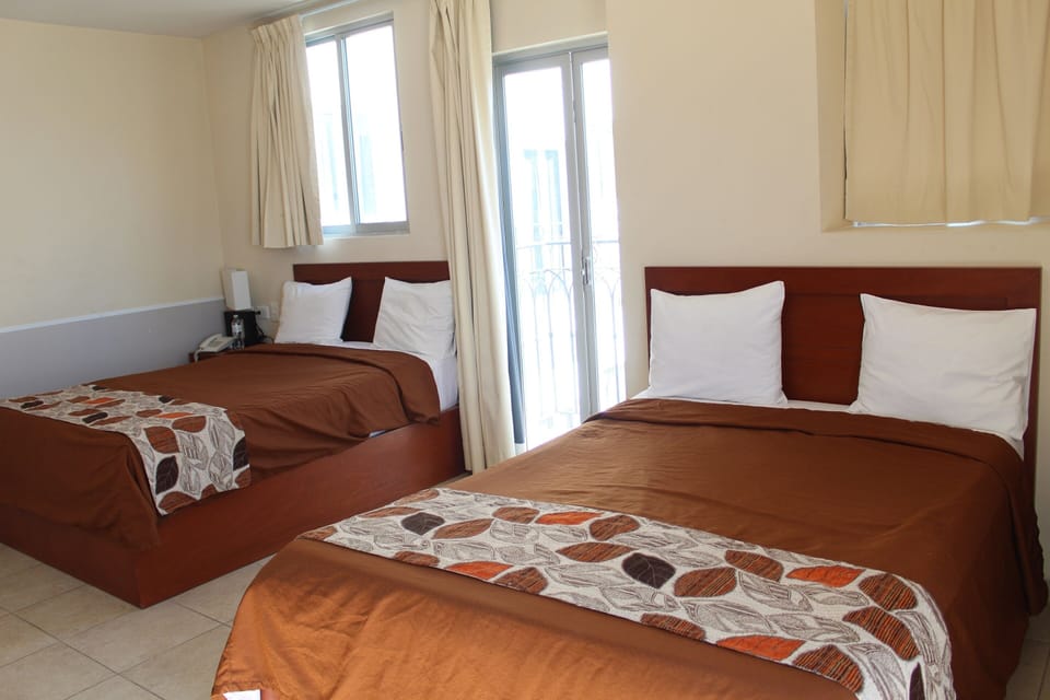 Executive Quadruple Room | Desk, iron/ironing board (on request), WiFi (free), bed sheets