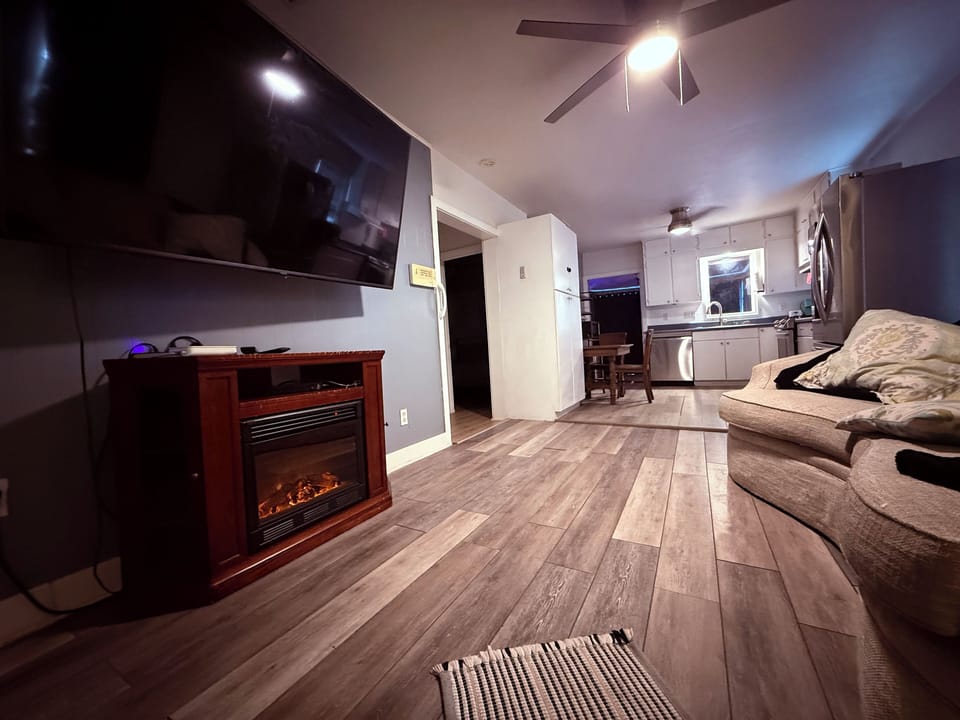 Cozy living room with large couch, large tv and fireplace