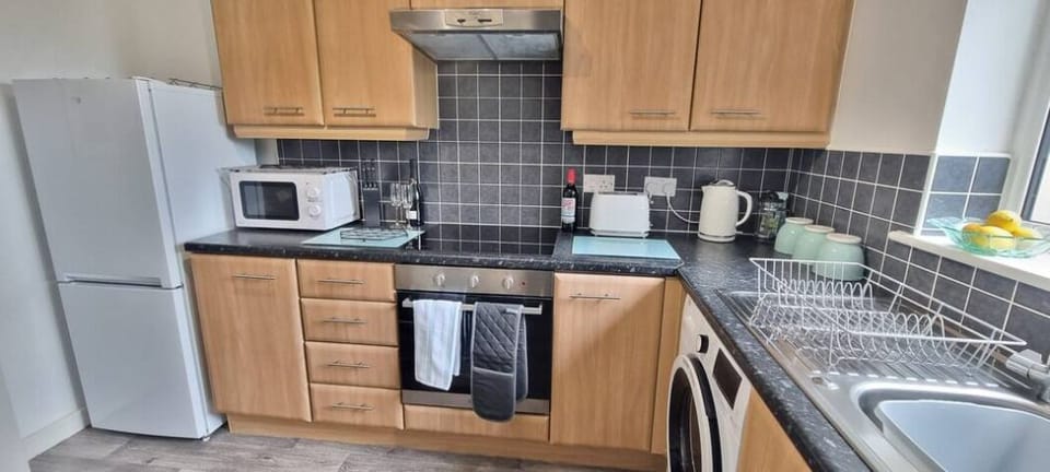 Comfort Apartment | Private kitchen | Full-size fridge, microwave, oven, stovetop