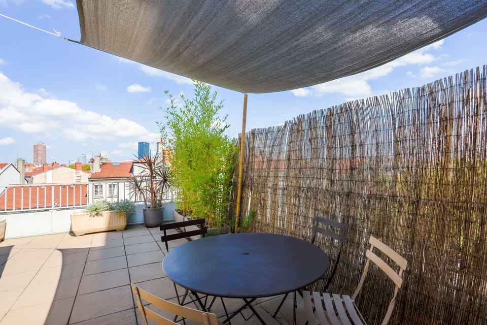 50 m2 terrace and dining area on the top floor of the building. View over the buldings of the Part Dieu business district