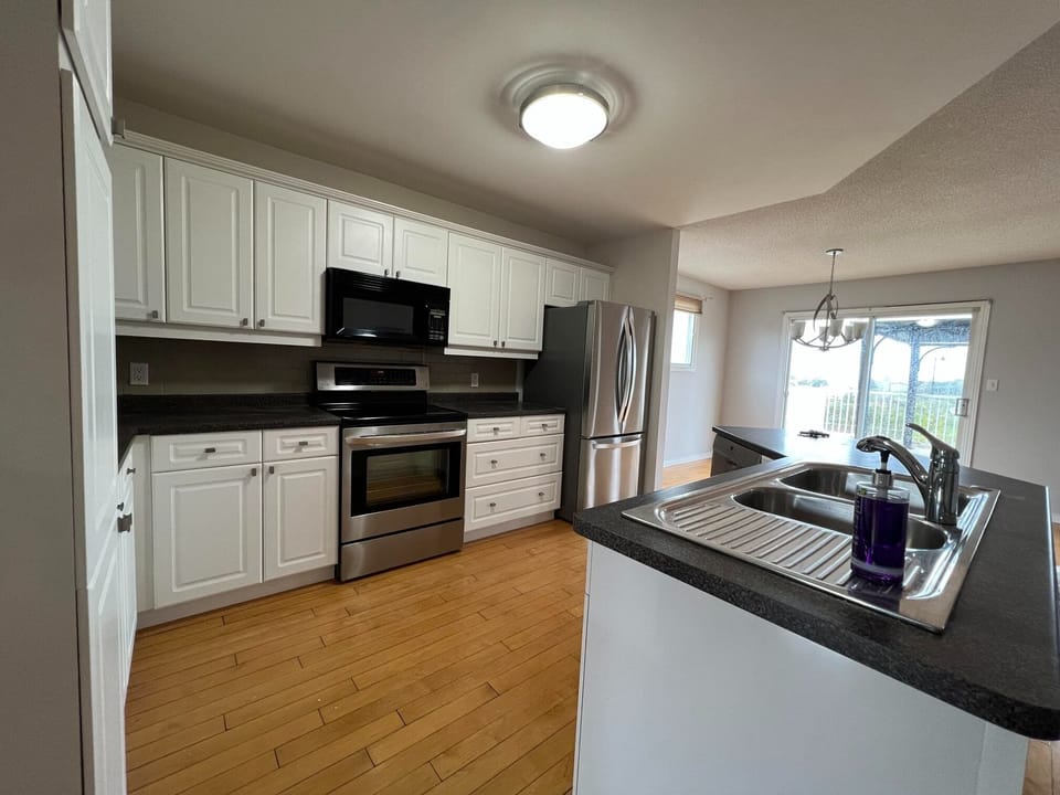 Full kitchen with dishwasher, fridge, stove, microwave