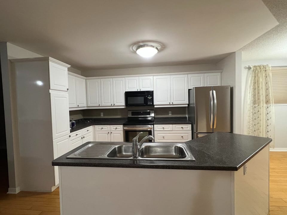 Full kitchen with dishwasher, fridge, stove, microwave