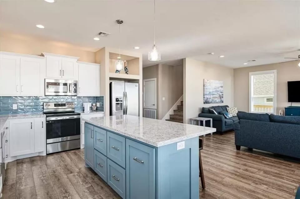 Bright open-concept kitchen with large island and stylish living area