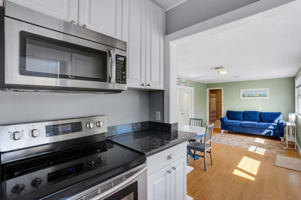 Fully equipped kitchen with modern appliances and basic cooking utensils.
