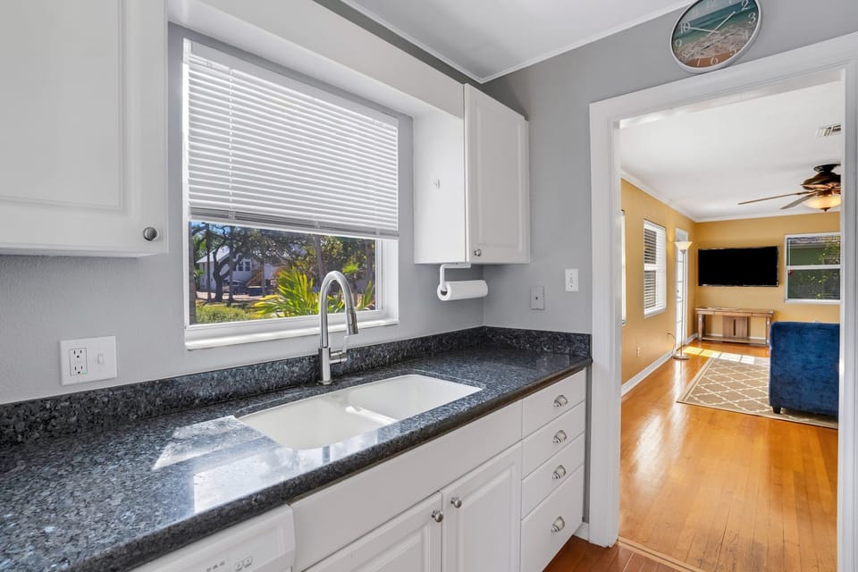 Fully equipped kitchen with modern appliances and basic cooking utensils.