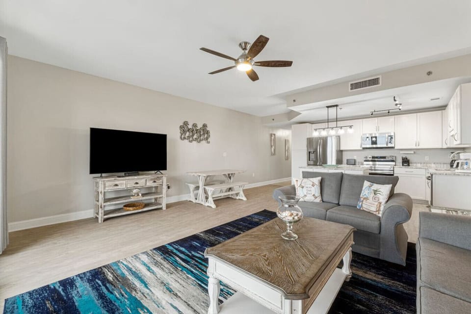 Living Area with Sleeper Sofa, Dining Table, Balcony Access & Lake Views