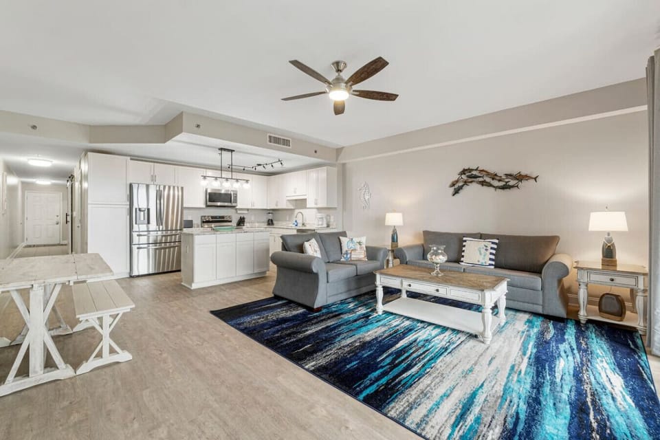 Living Area with Sleeper Sofa, Dining Table, Balcony Access & Lake Views