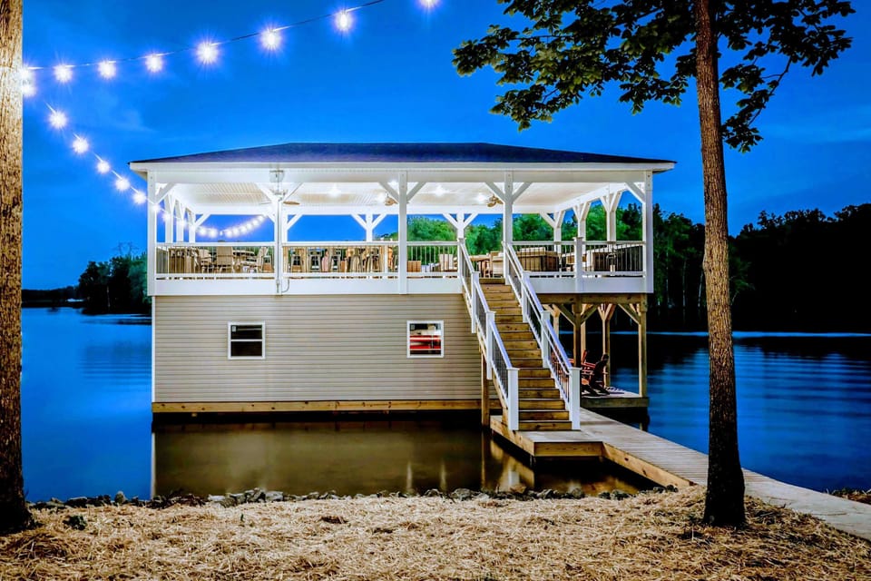 Experience serene lakeside relaxation at our charming huge boathouse, complete with twinkling string lights and a spacious deck, perfect for evening unwinding and morning tranquility!