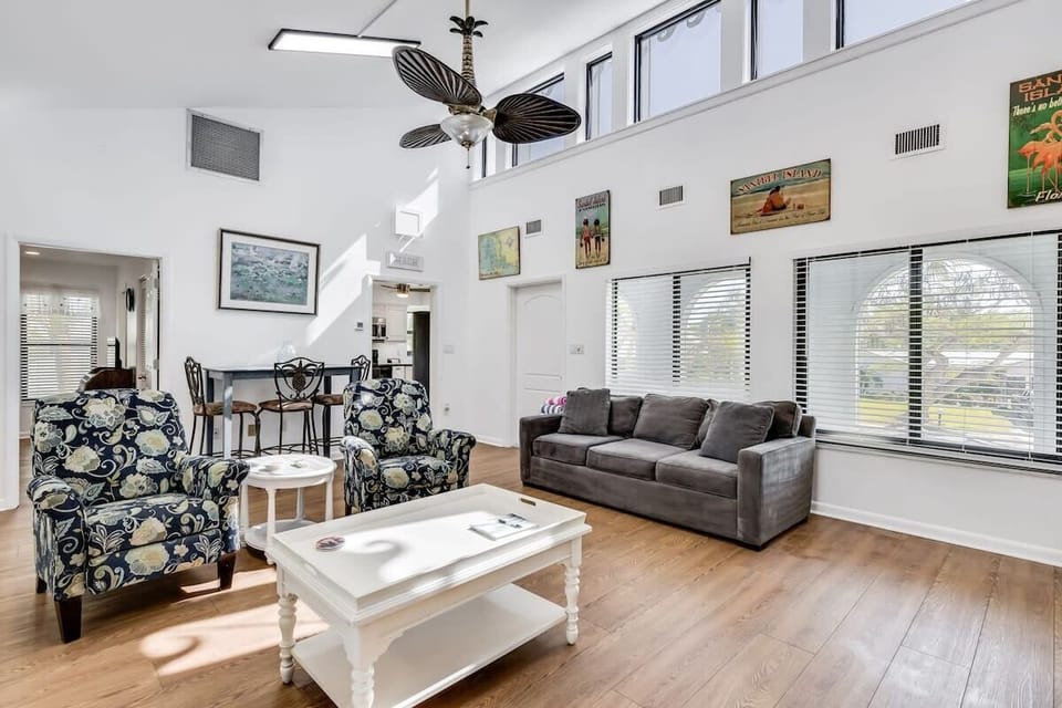 Gorgeous light filled living area with ample seating and flat screen TV