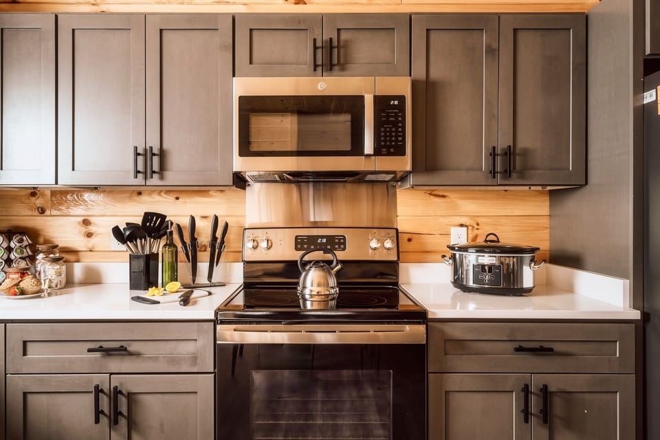 Brand new kitchen with stainless steel appliances.