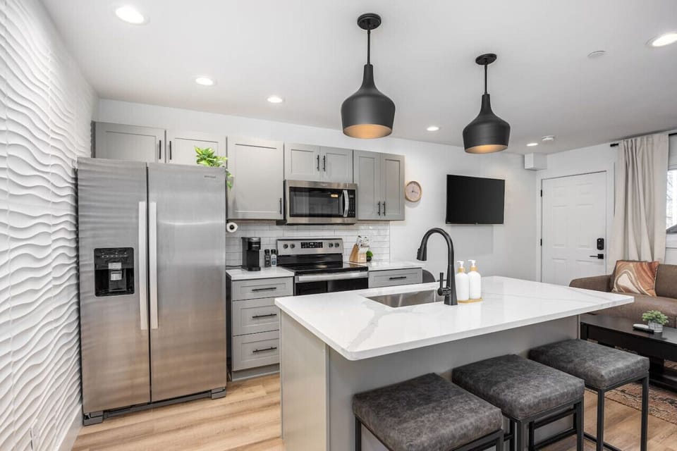 Fully-stocked modern kitchen with all the appliances and utensils you might need to enjoy a meal at home. Coffee provided for the Keurig and seating for 3 at the kitchen counter.