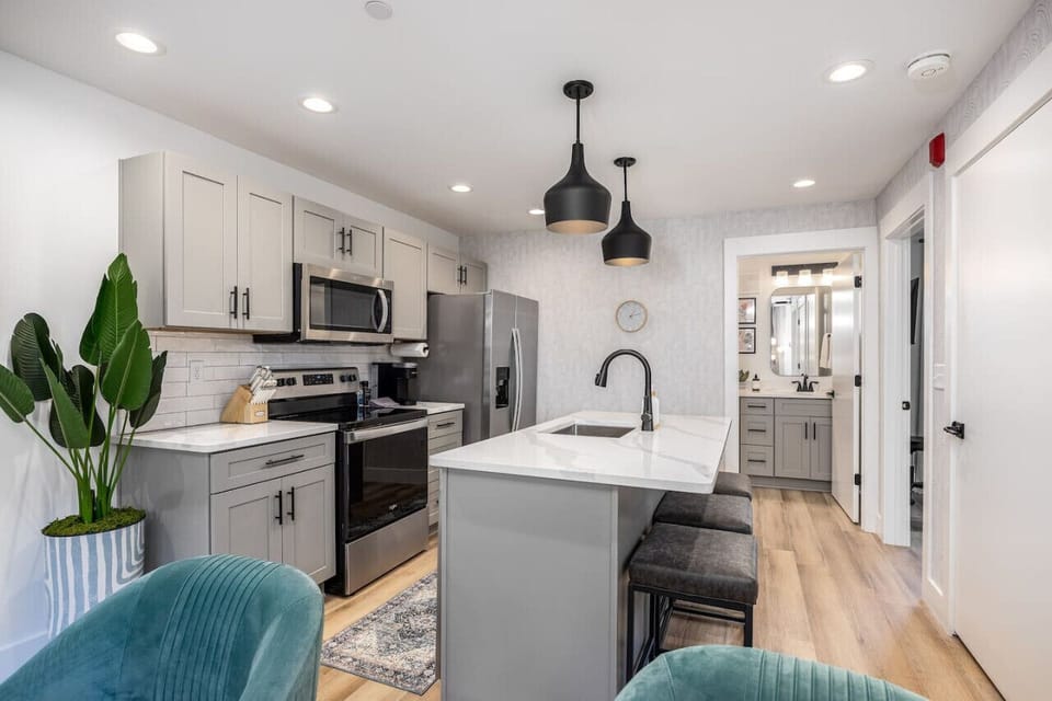 Fully-stocked modern kitchen with all the appliances and utensils you might need to enjoy a meal at home. Coffee provided for the Keurig and seating for 3 at the kitchen counter.