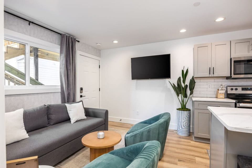 Cozy living room with a Smart TV, Pull-out couch, and room-darkening shades.
