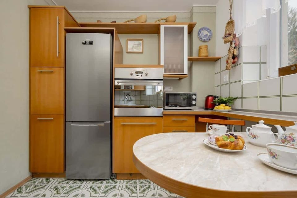 Fully equipped kitchen with cooking appliances and dining area.