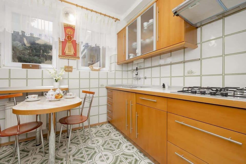 Dining area and kitchen with cooking appliances.