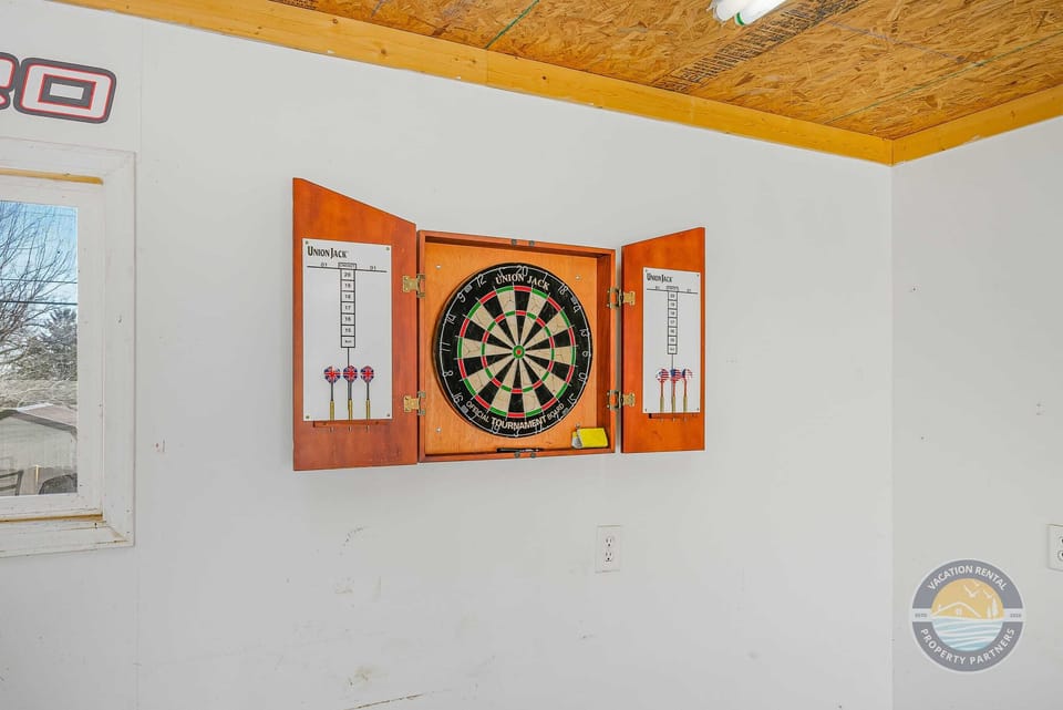 Step into the garage hangout space for even more fun, featuring a dartboard setup perfect for casual games. A great bonus spot for friendly competition and extra entertainment during your Lake Geneva getaway.