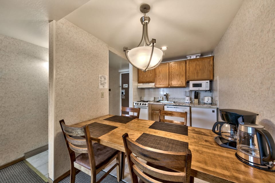 Gather around your own dining table where warm wood meets modern convenience, creating the perfect spot for morning coffee or evening meals.