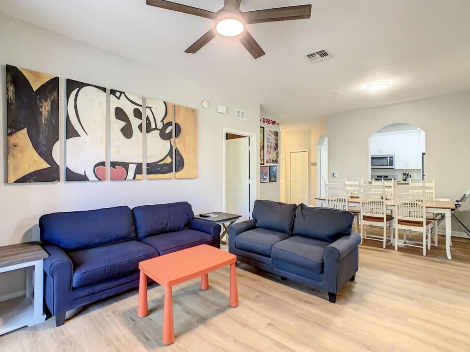Enjoy this cozy living room with fun Mickey-themed wall décor!