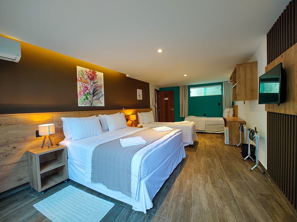 Comfort Quadruple Room, Patio | Minibar, individually decorated, desk, laptop workspace