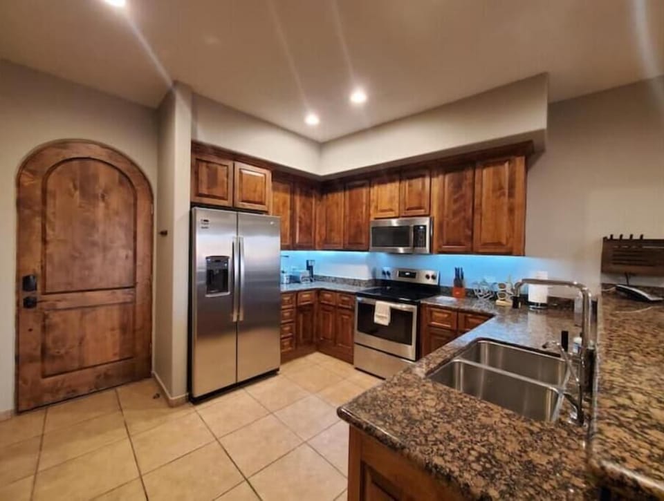 Stocked kitchen with all tools, pots, pans, dishware, spices & seasonings.